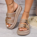 Women's apricot suede slippers with a thick light-coloured rubber sole, shown from the side.