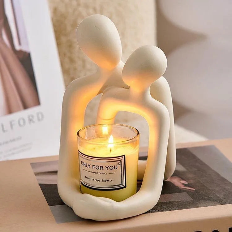 Modern couple resin statue in gold colour placed on a white bookshelf as home decor accent