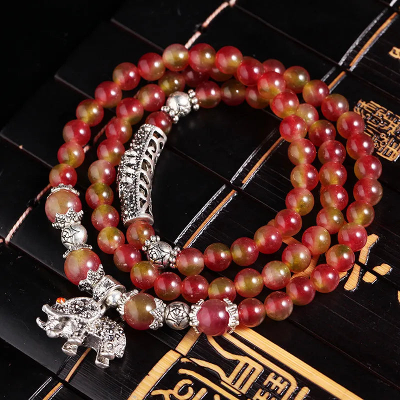 Handmade geometric bracelet made from natural watermelon crystal beads with a traditional Chinese knot clasp.