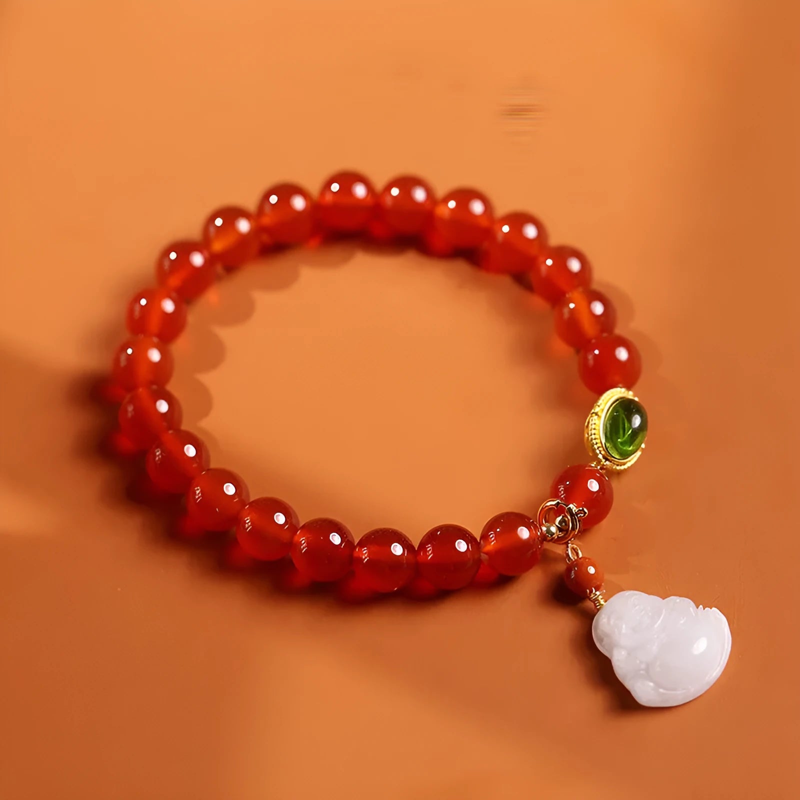 Chinese style women's bracelet with red agate, amber beads and gold Maitreya Buddha pendant on wrist