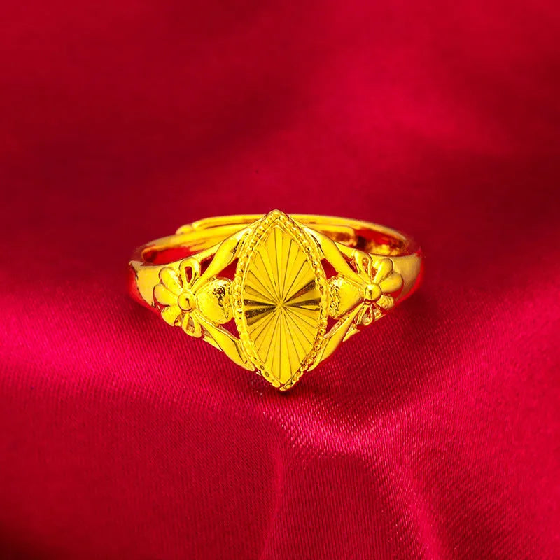 Gold coloured open diamond flower shape ring with geometric textured details on a brass base.
