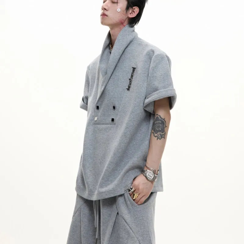 Men's dark grey V-neck padded shoulder short sleeve cotton jacket with metal details and matching trousers.