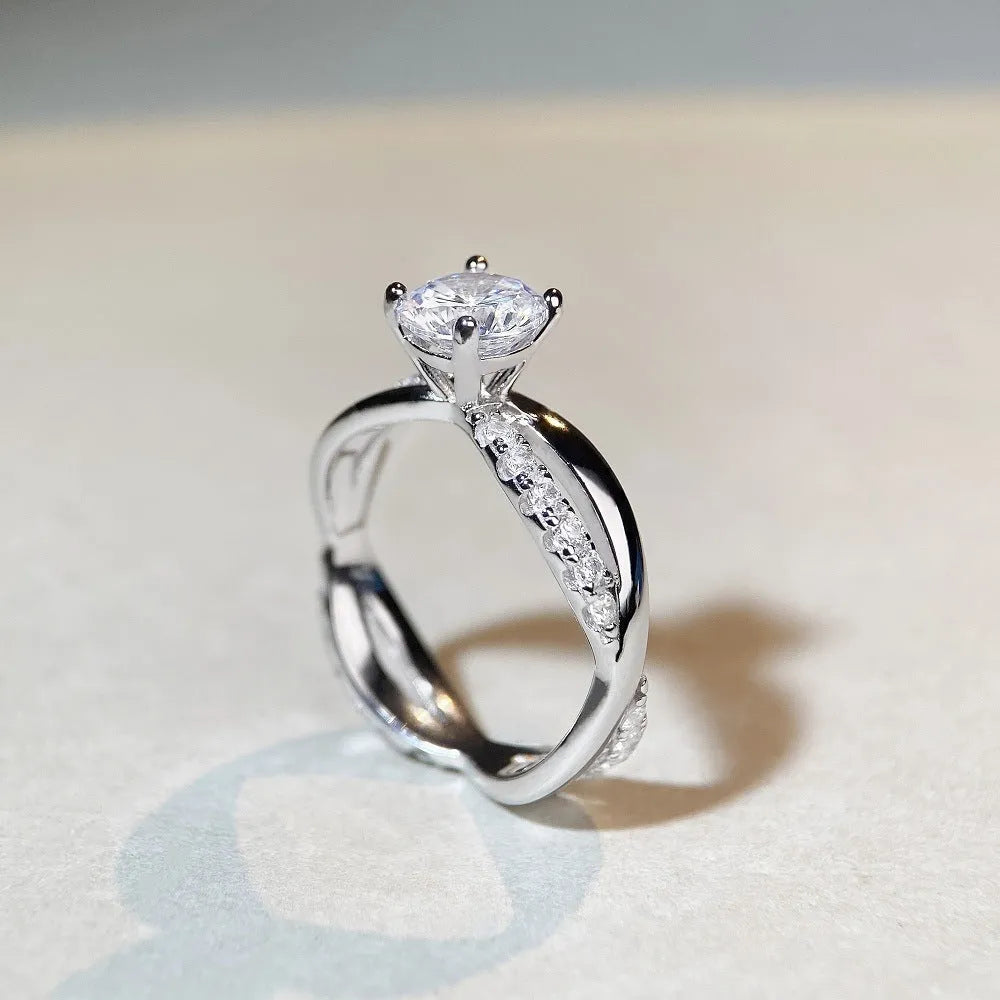 Silver moissanite ring with 1 karat stone and cross twisted arm geometric design