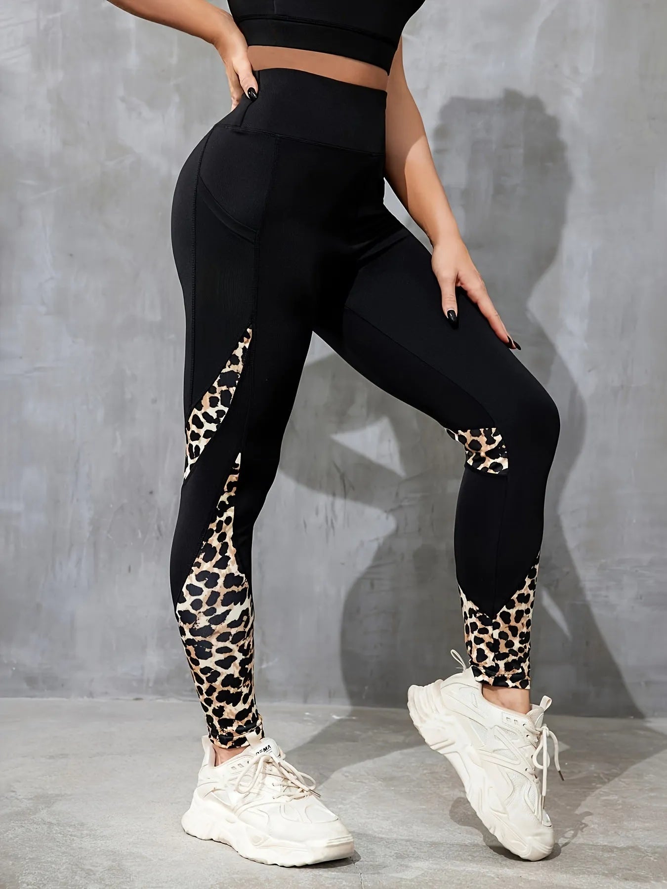 Woman wearing black ribbon letters colour contrast patchwork high waist yoga leggings with pocket