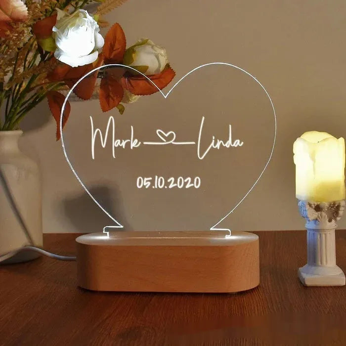 Custom acrylic LED night light displaying engraved names and dates on clear 20cm by 11.5cm panel
