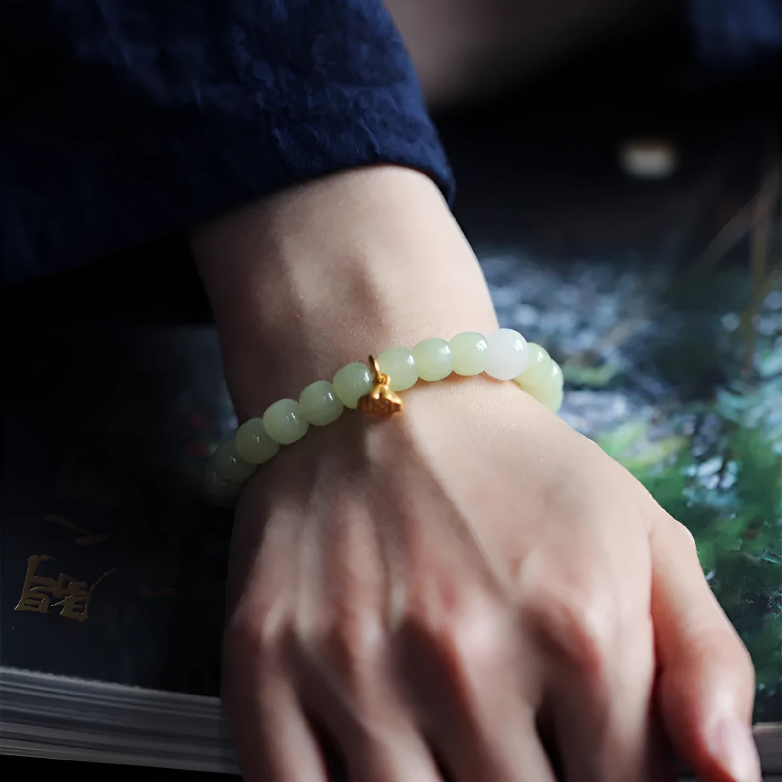 Green jade bracelet with vintage beads on white background, ethnic style women's jewellery