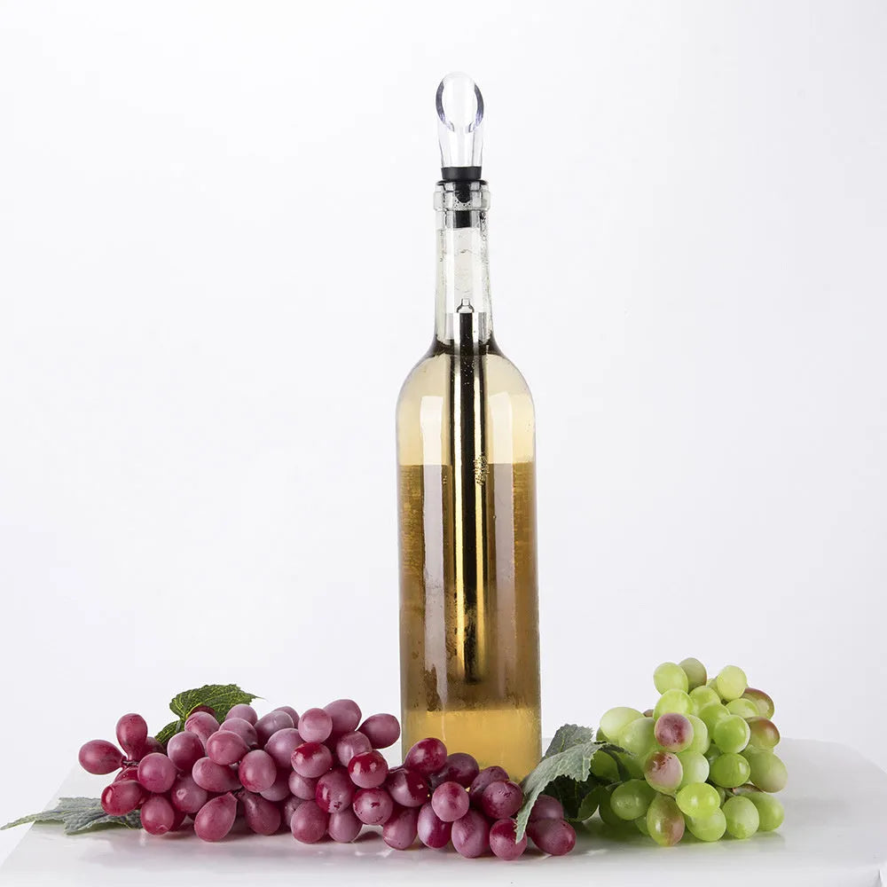 Silver stainless steel wine bottle cooler stick with built-in aerator and drip-free pouring nozzle on a table