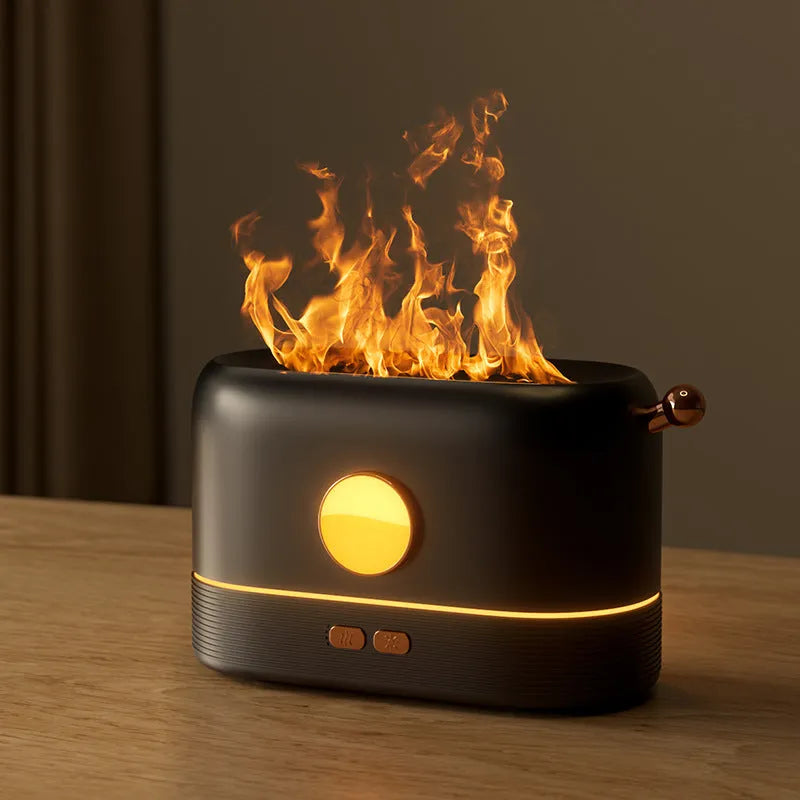 Black USB humidifier with simulated flame effect and mist output on a wooden desk