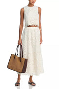 White women's sleeveless suit top with matching embroidered long skirt set