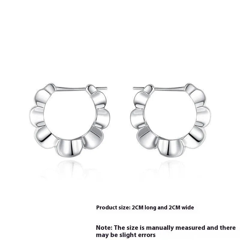 A pair of sterling silver geometric earrings with round details and an electroplated finish.