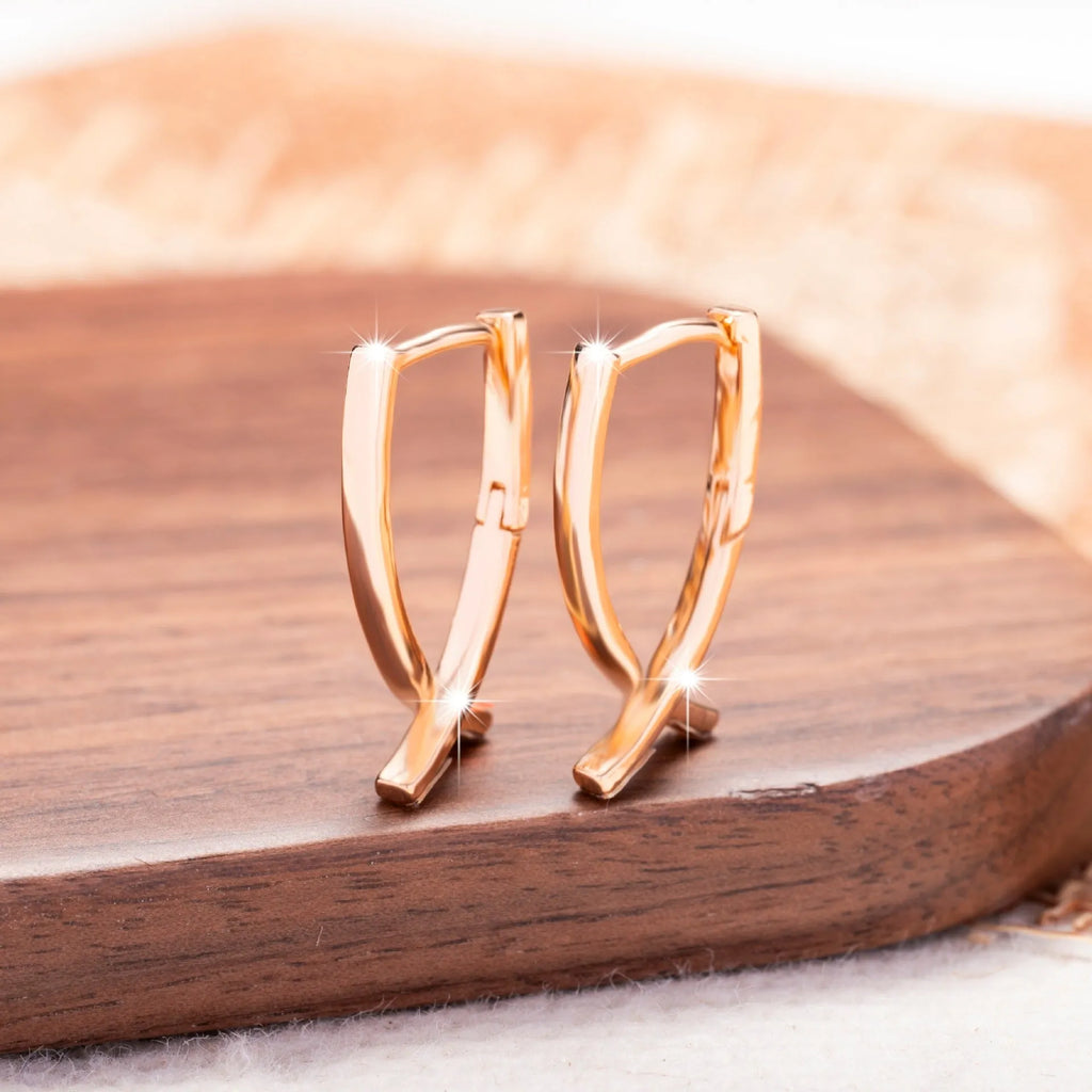 Rose gold plated copper cross earrings with symmetrical design and post fittings