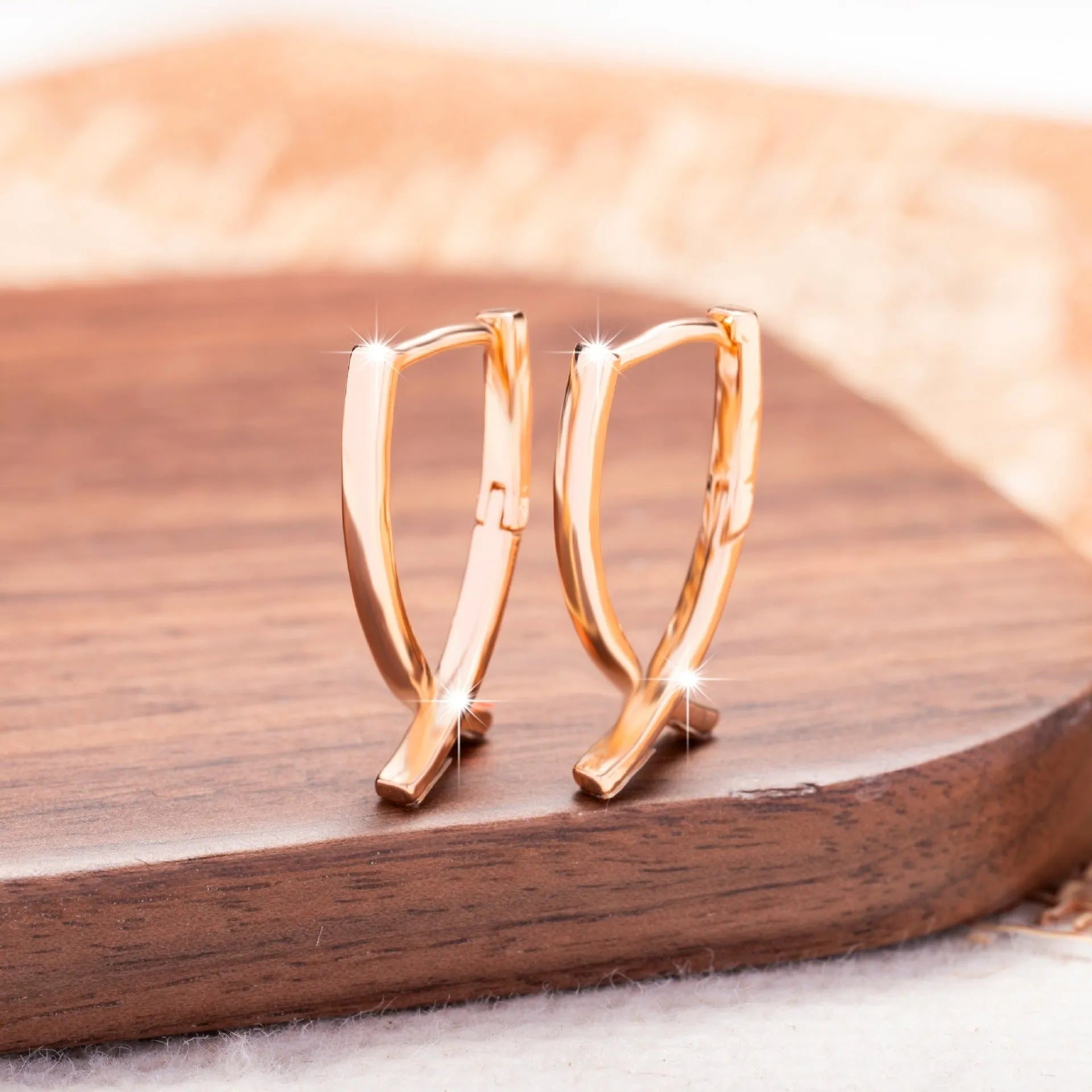 Rose gold plated copper cross earrings with symmetrical design and post fittings