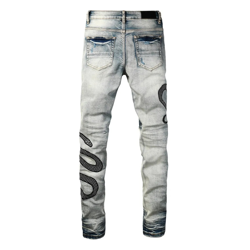 Blue distressed wash skinny jeans with a button fly and elasticated mid-rise waistband on a mannequin.