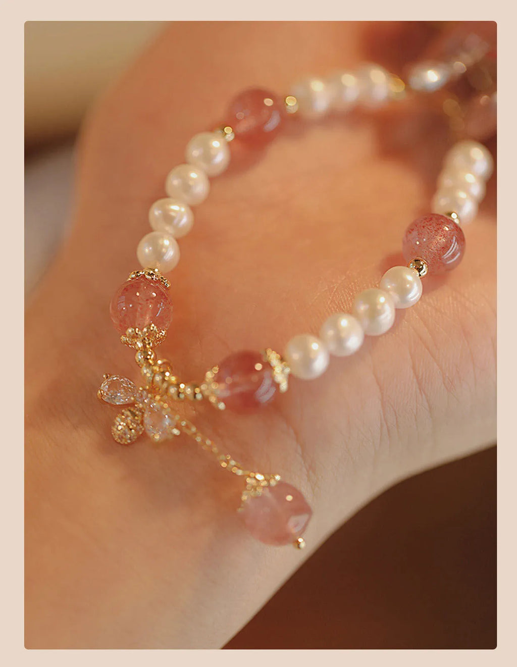 Crystal strawberry quartz bracelet with bow detail on white background, women's INS-style accessory