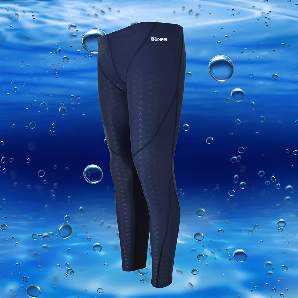 Men's nylon swimming trunks in black with grey trim, showing cropped brief style with mesh lining