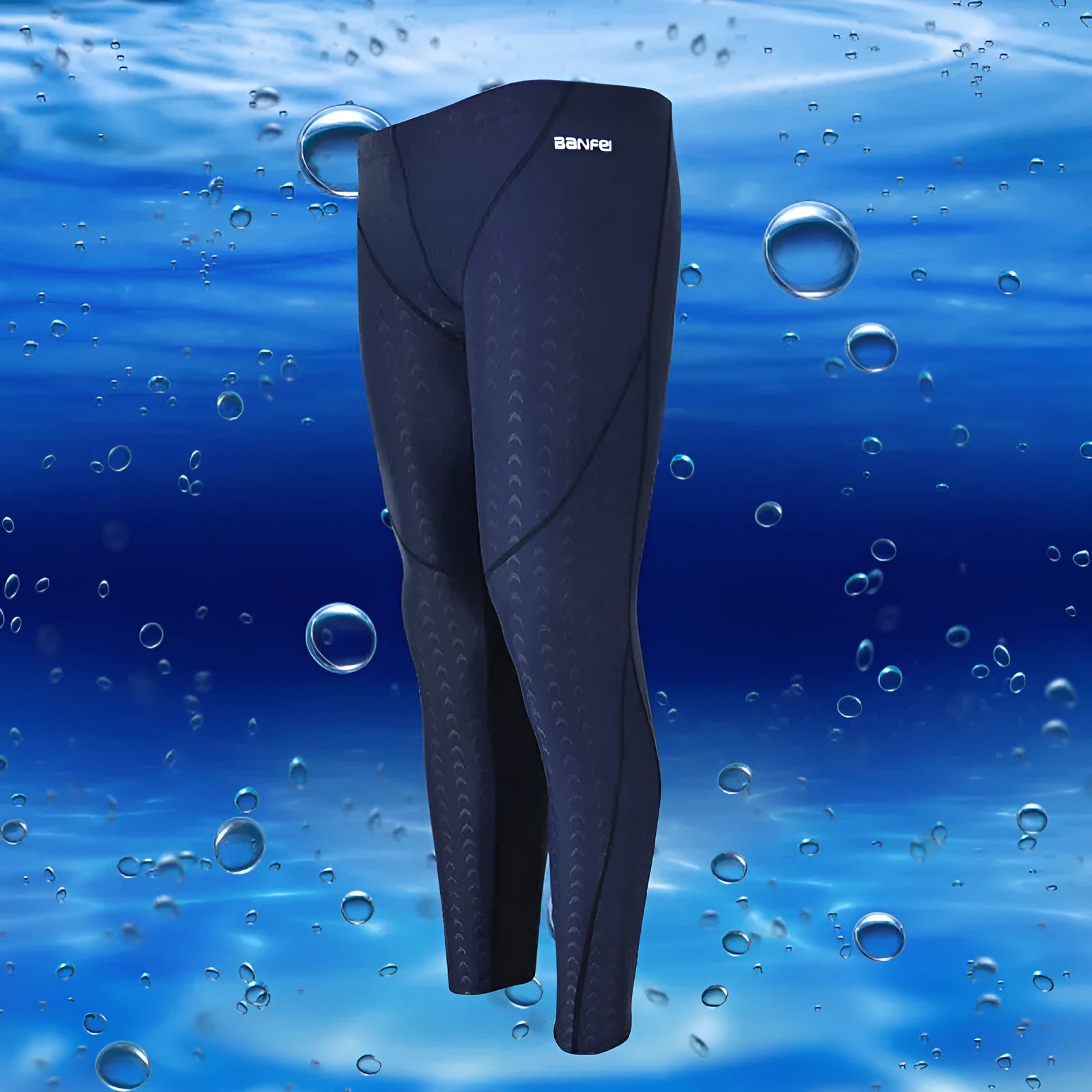 Men's nylon swimming trunks in black with grey trim, showing cropped brief style with mesh lining