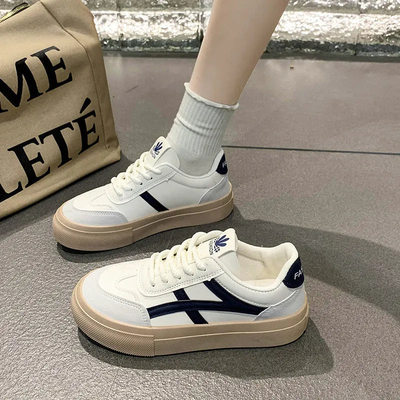 Blue and brown low-top women's borad shoes with patent leather upper and flat rubber sole.