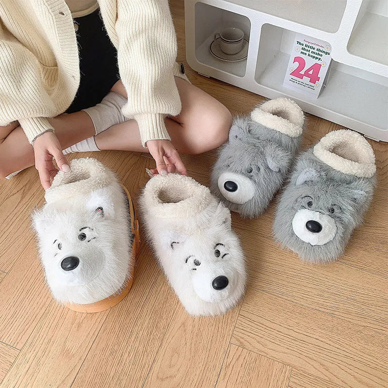 Pair of grey ankle wrap cotton slippers with plush upper and artificial wool lining on a home floor