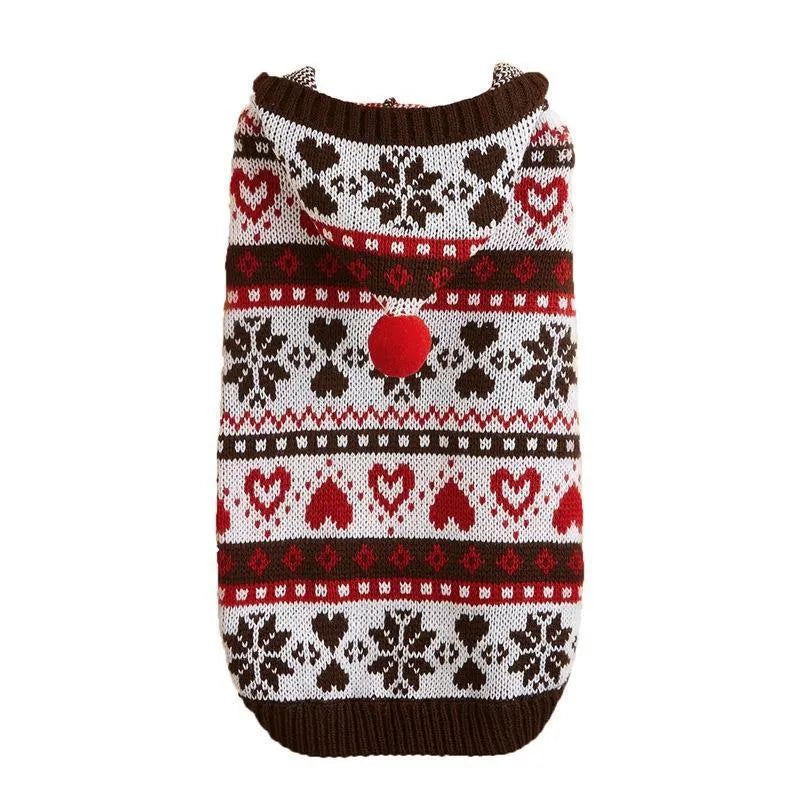 Blue knitted dog sweater with snowflake and camouflage patterns on a small white dog.