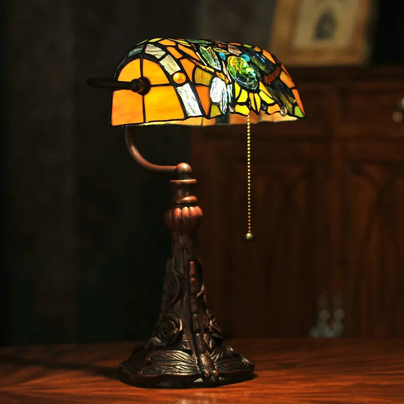 Tiffany stained glass table lamp with coloured glass shade on resin base for desk lighting