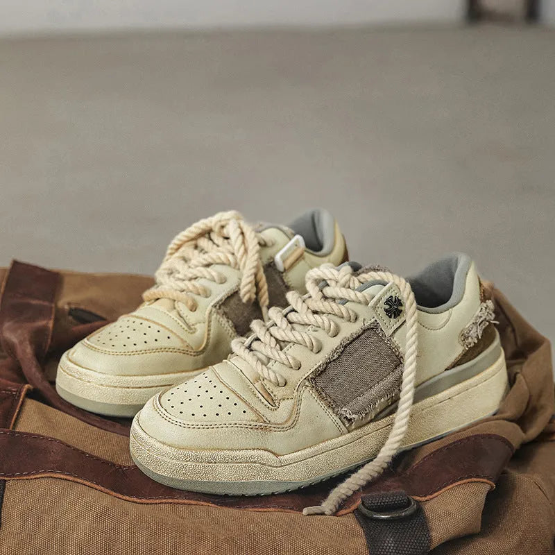 Beige low top skateboard shoes with rubber sole and front lace-up design