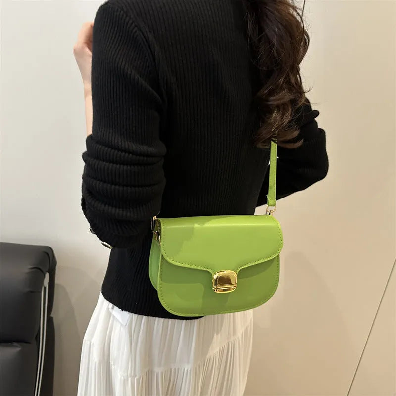 Simple PU leather handbag for women with zipper closure, available in multiple colours including black, brown, and green