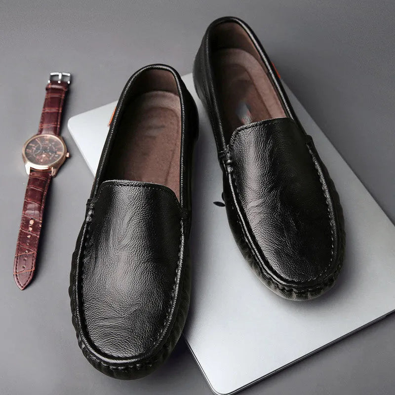 Mens brown casual driving shoes with leather upper, round toe, and stitching detail on a white background