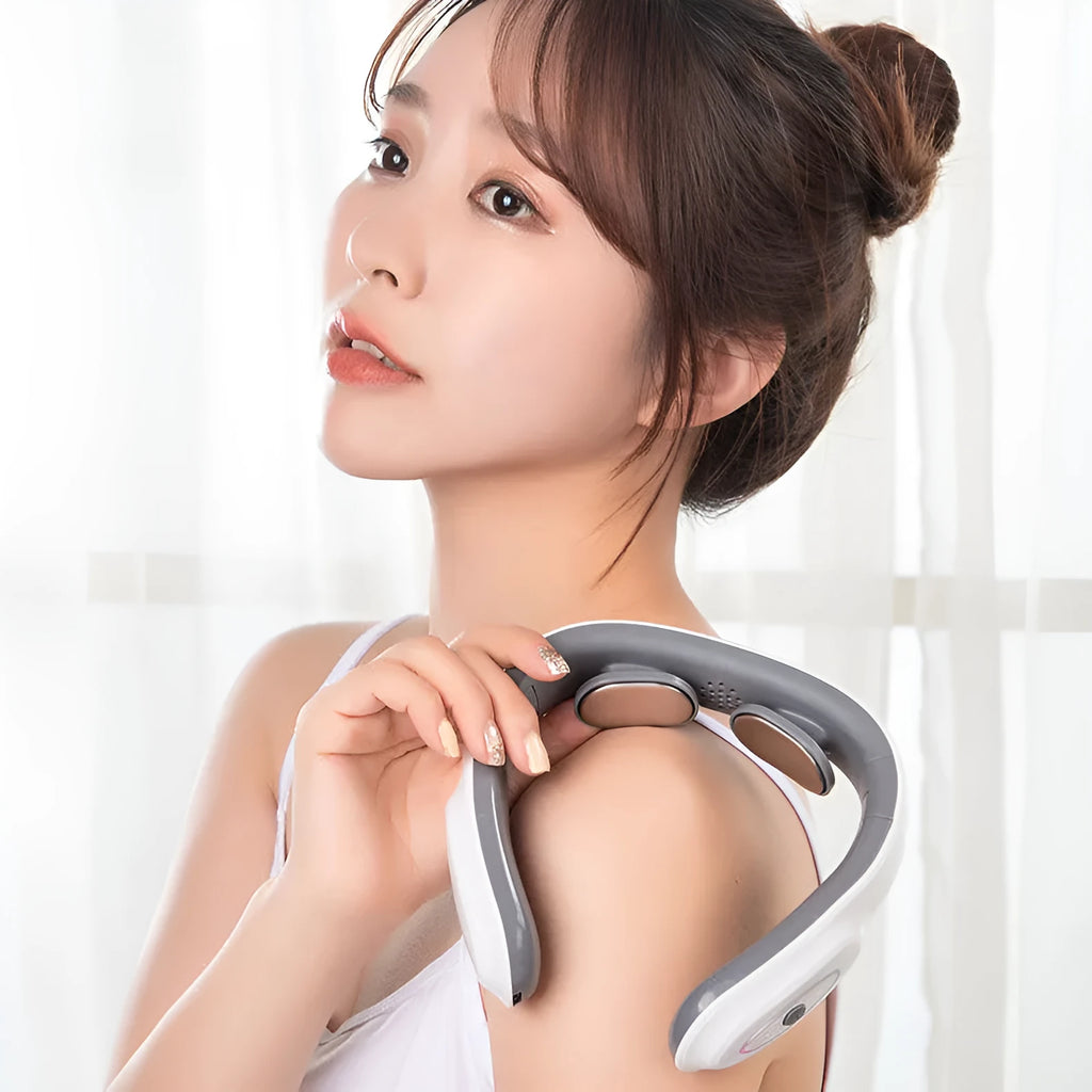 White electric pulse shoulder and neck massager with hot compress, folded compactly on a table