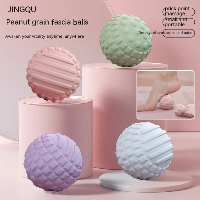 Blue TPR foot massage ball on a wooden floor, 6cm diameter, next to a green peanut ball variant.