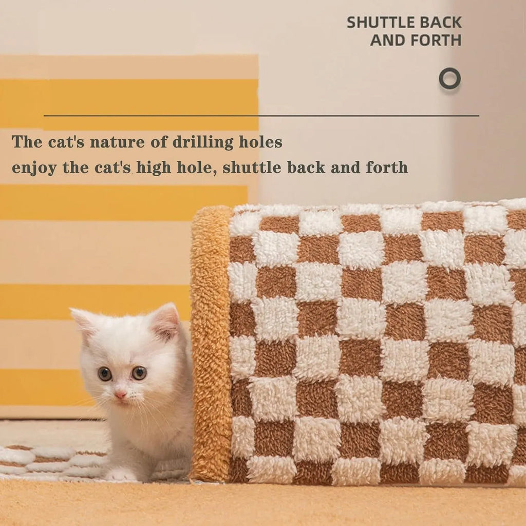 Brown plaid plush cat tunnel bed with a central mat on a wooden floor.
