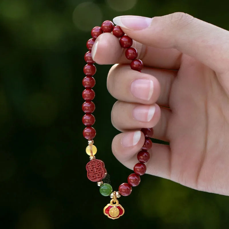 Happy eyebrow bracelet with emperor sandstone beads and a central carved fu charm on a string.