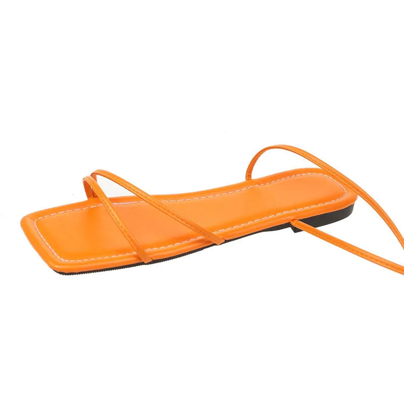 Women's flat sandals with ankle ring bandage detail and front lace-up in square toe design.