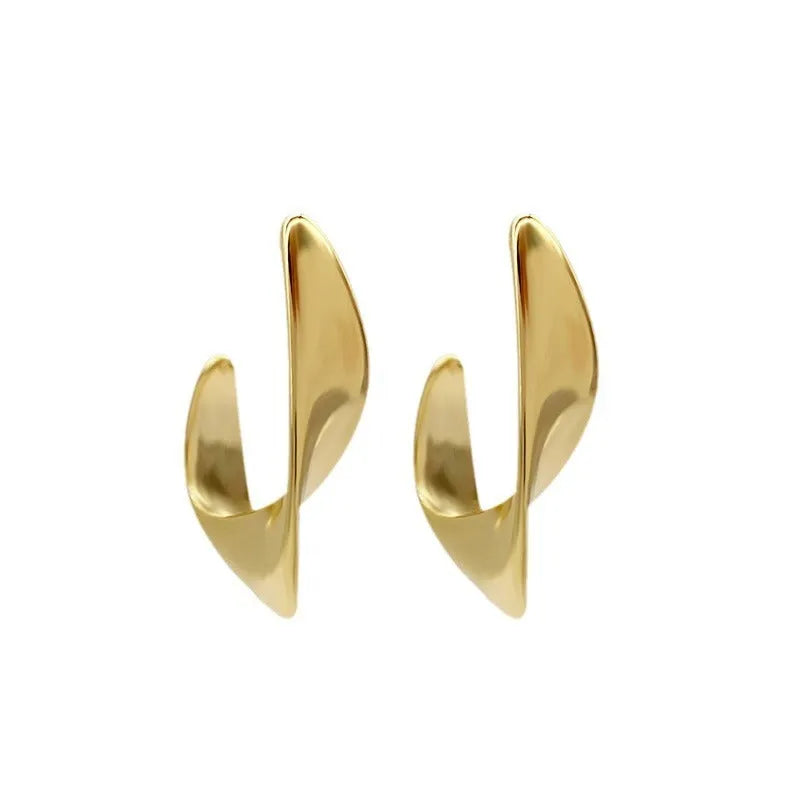Gold twisted geometric metal earrings with round design elements