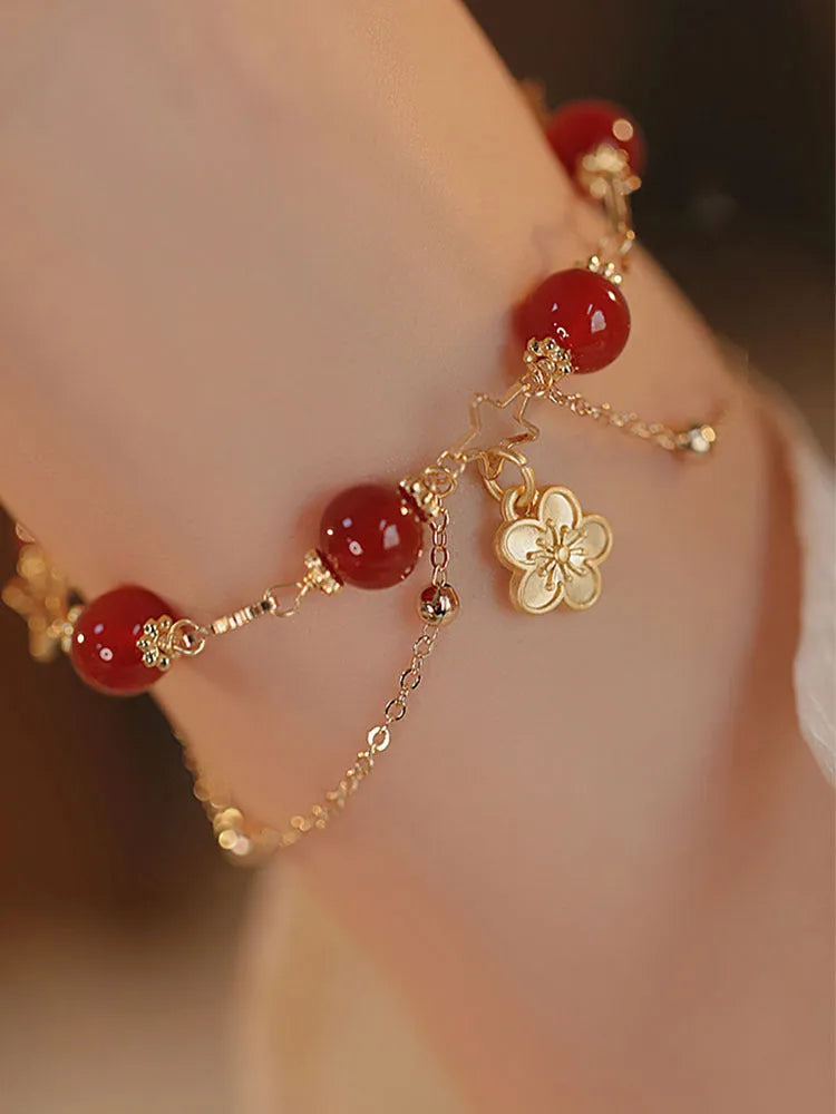 Red agate double layer bracelet with peach blossom decoration on female wrist