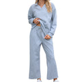 Women's black knitted jacquard sweater and cropped elastic waist pants co-ord set showing geometric pattern detail.