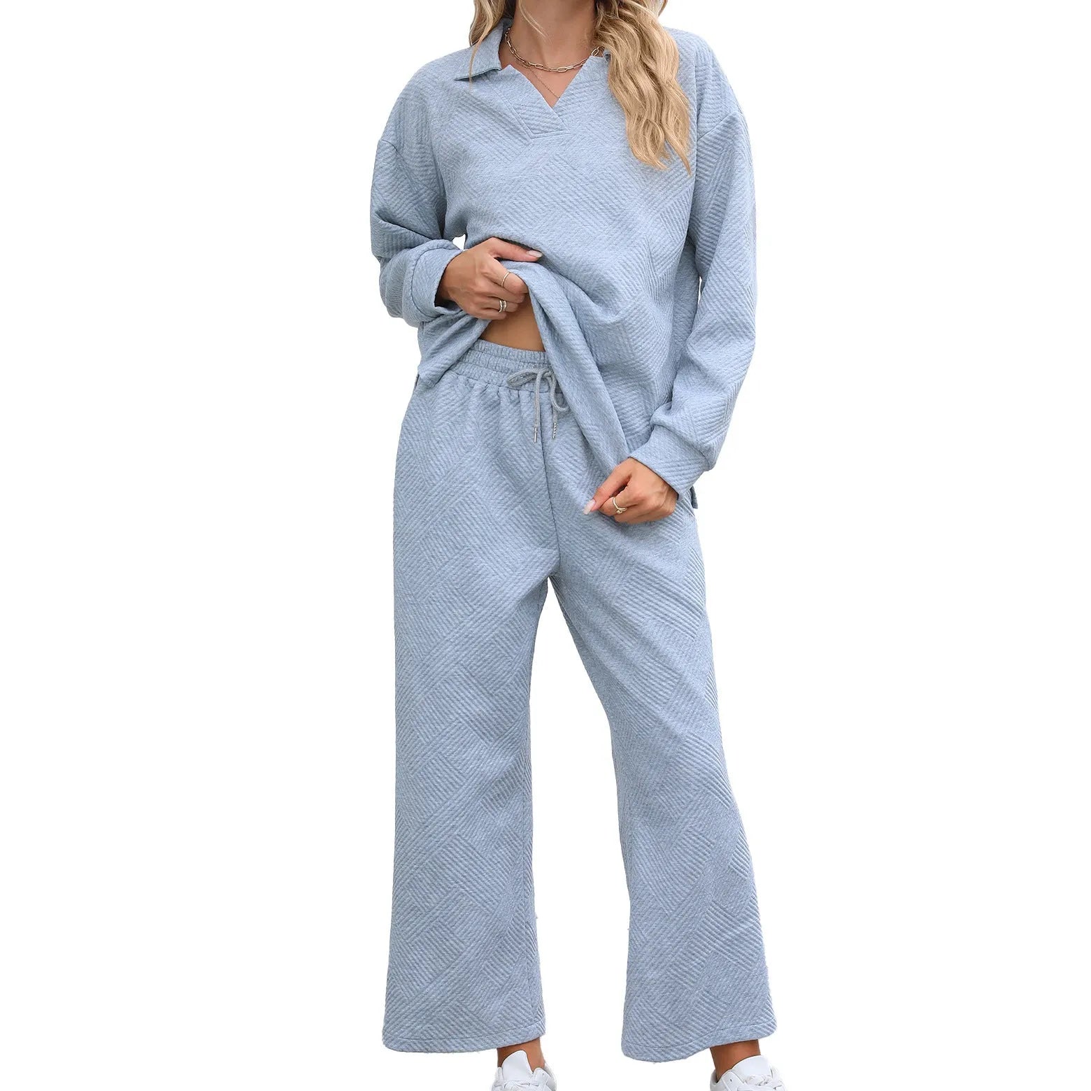 Women's black knitted jacquard sweater and cropped elastic waist pants co-ord set showing geometric pattern detail.