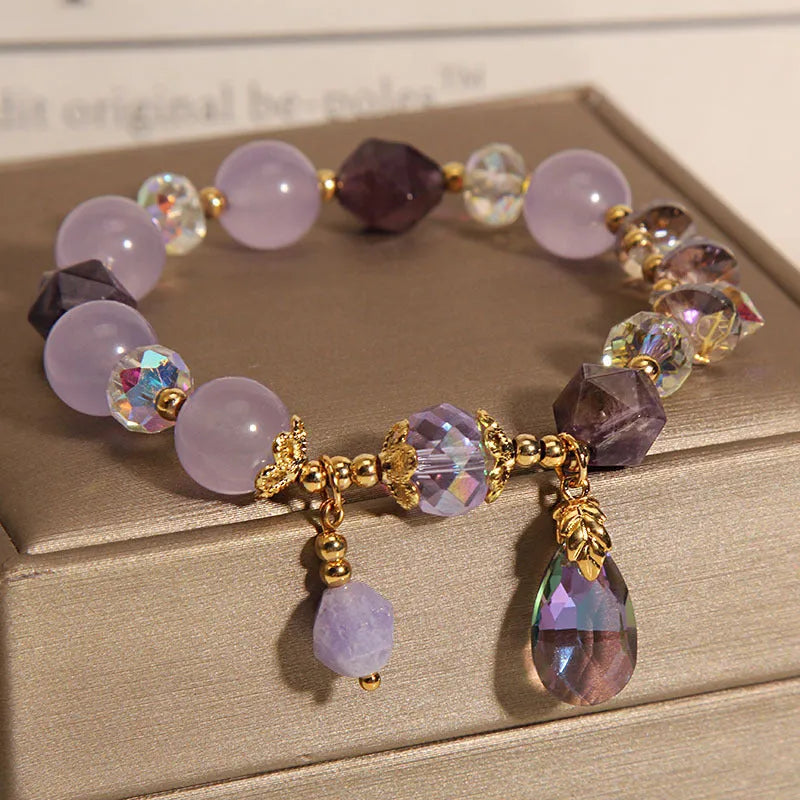 Children's crystal bracelet with lavender purple water-drop crystals on a plain background