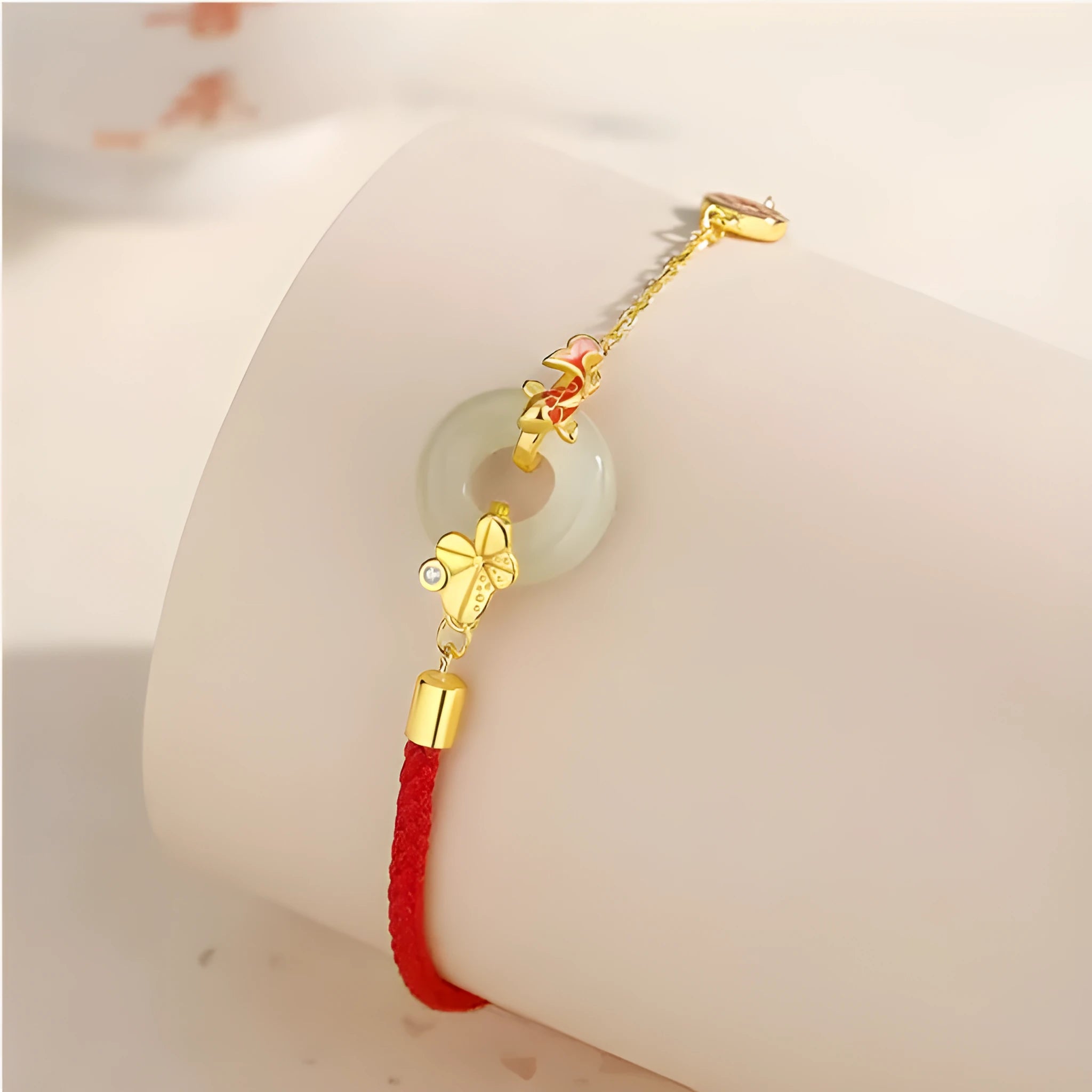 Gold 925 silver koi peace buckle bracelet with red rope on white background