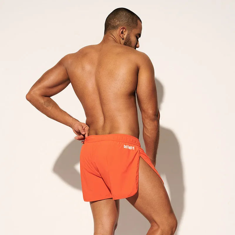 Men's loose beach surfing shorts in orange, green or black with elastic waistband