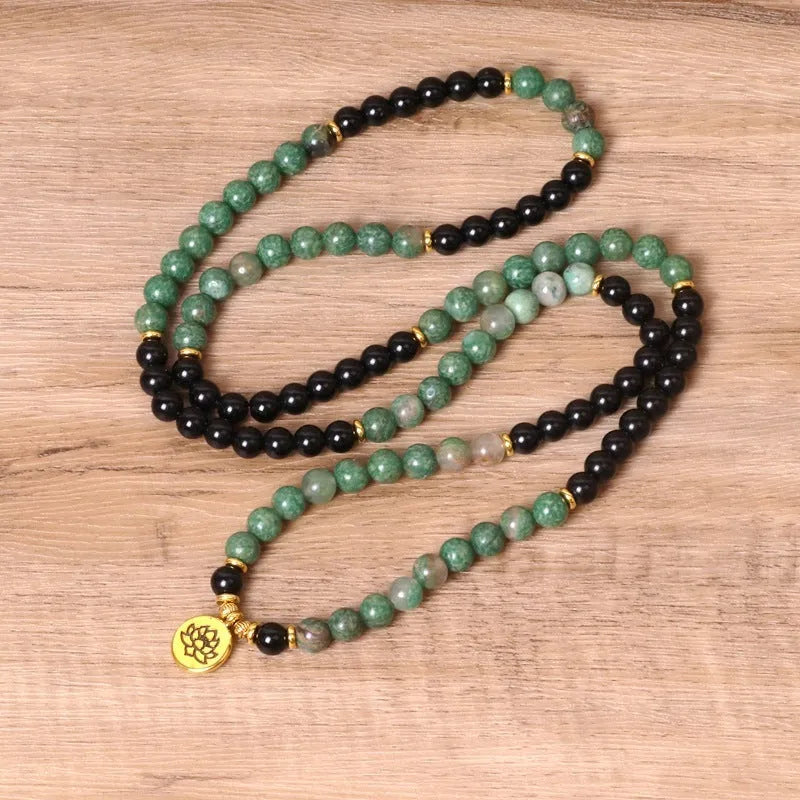 Green and black elastic beaded alloy bracelet with stretch design on wrist