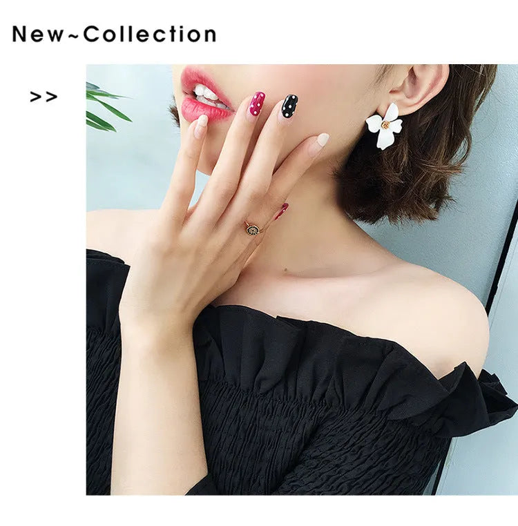 A pair of flower-shaped stud earrings for women in either pink or white alloy with an electroplated finish.