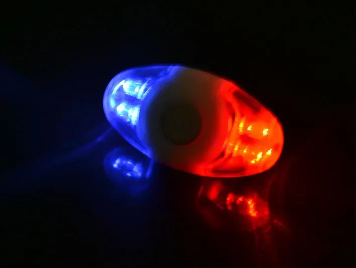 Red and blue LED tail light with adjustable mounting base showing horizontal and vertical positioning options