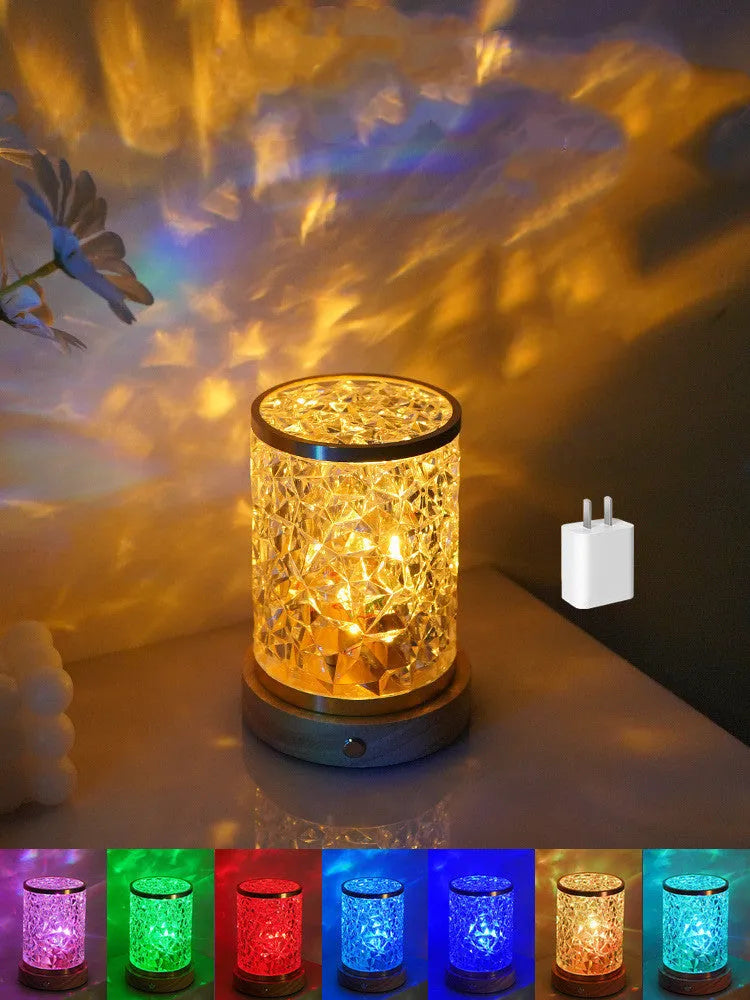 Small modern acrylic and wood water ripple night light with rotating base on a bedside table.