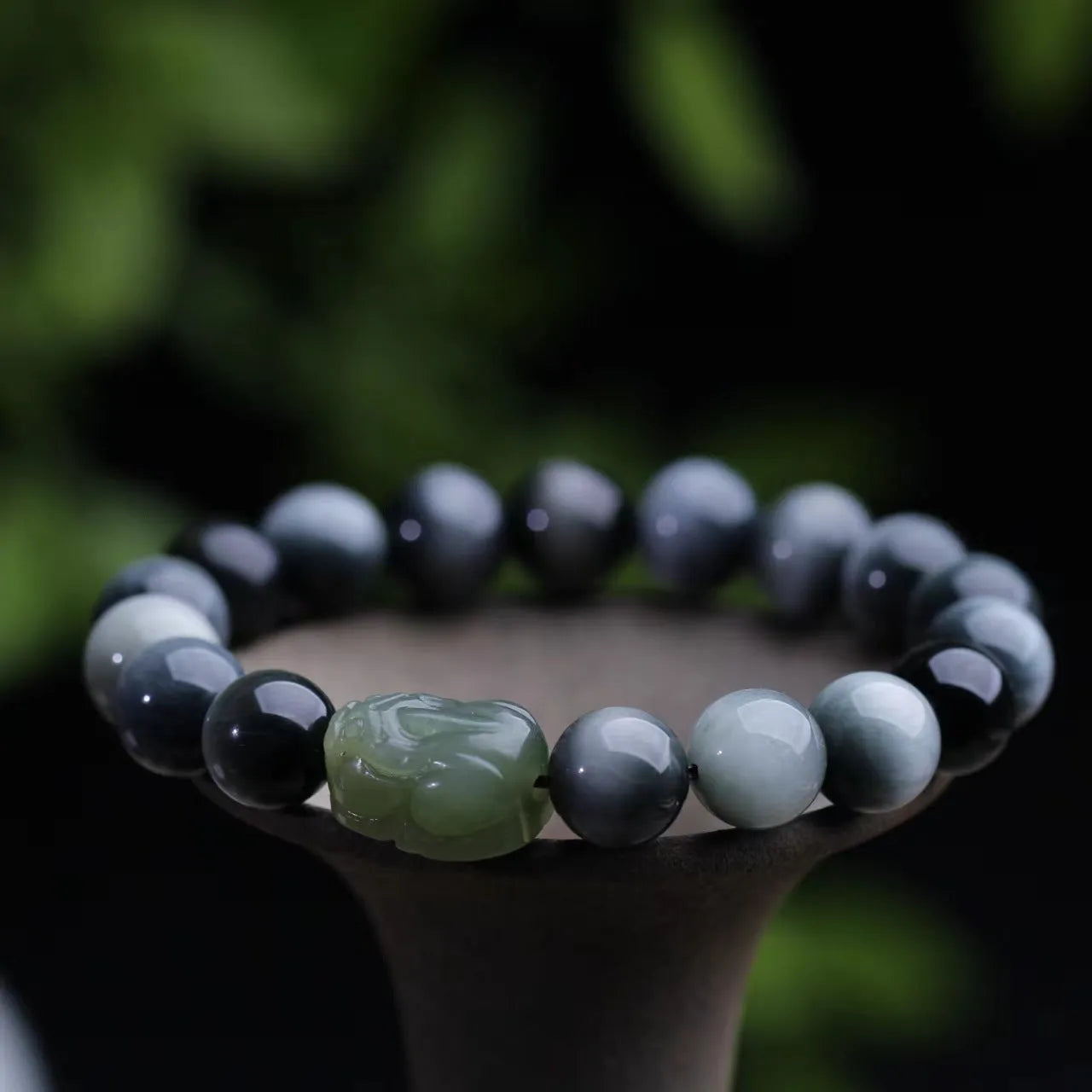 10mm black eagle eye stone and natural Hetian jade clear water Pixiu bracelet on a neutral background