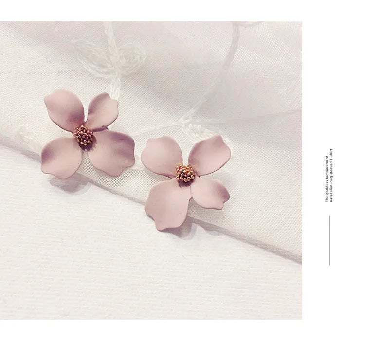 A pair of flower-shaped stud earrings for women in either pink or white alloy with an electroplated finish.