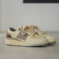 Beige low top skateboard shoes with rubber sole and front lace-up design