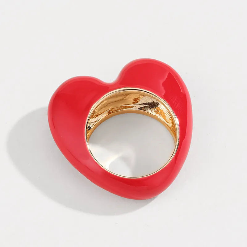 Three-dimensional heart-shaped enamel ring in multiple colours on a zinc alloy band.
