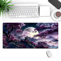 Large black gaming mouse pad with geometric pattern, measuring 40cm by 90cm, on a wooden desk.