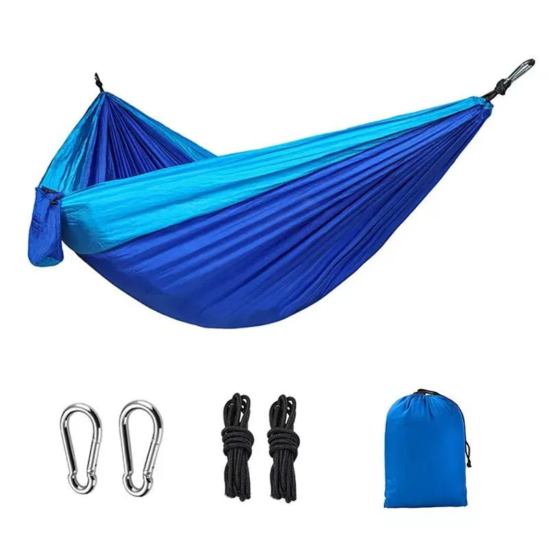 Blue nylon outdoor camping hammock with 300kg load capacity shown suspended between trees