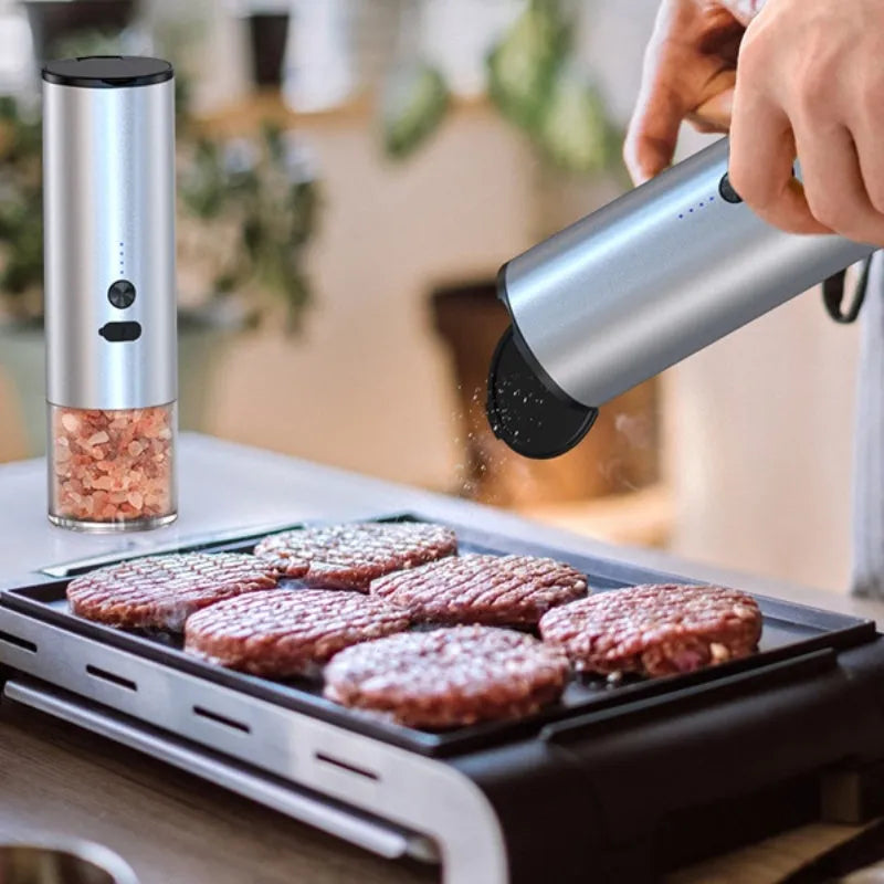 Rechargeable electric pepper and salt grinder with LED light and stainless steel top on white background